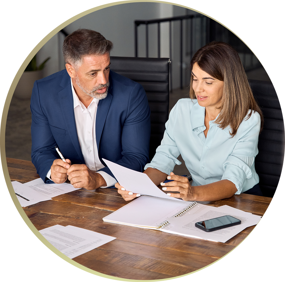 Man and woman discussing documents at table.