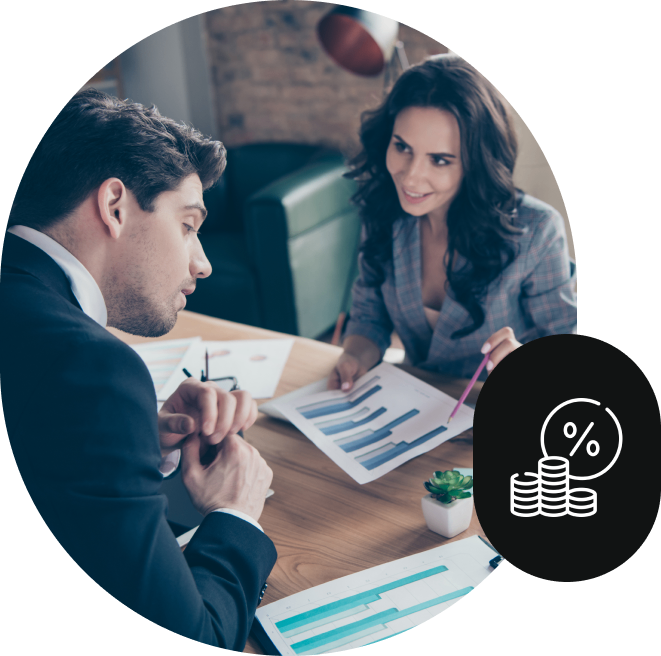 Two colleagues discussing financial charts together.